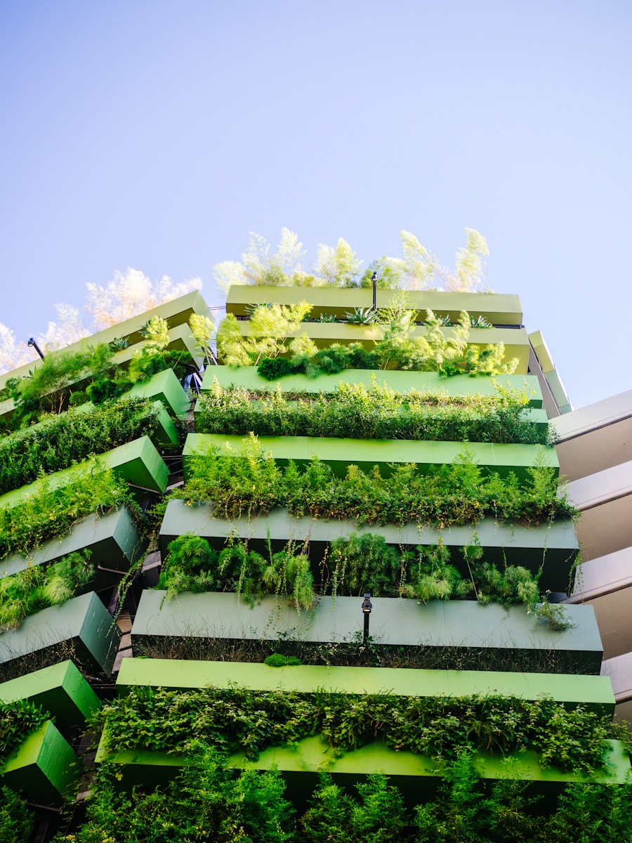 Photo by Charles Etoroma green and yellow plants on white concrete building